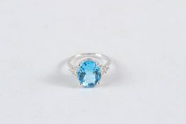 A 9CT GOLD, BLUE TOPAZ AND DIAMOND RING.