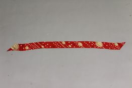 CARTIER, PARIS, A RED SILK CRAVAT, decorated with Cartier logo and dots, with Cartier bag. 160cms