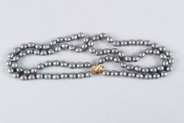 A TAHITIAN PEARL NECKLACE with gold clasp.