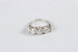AN EDWARDIAN PLATINUM AND DIAMOND FIVE STONE RING, set with 2.5 carats of old cut diamonds.