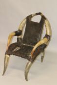 AN UNUSUAL BUFFALO HORN FRAMED AND LEATHER UPHOLSTERED ARMCHAIR.