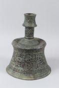 AN EARLY ISLAMIC, POSSIBLY PERSIAN, OPEN WORKED BRONZE CANDLESTICK. 28cms high.