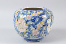 A 19TH CENTURY PERSIAN QAJAR SIGNED GLAZED POTTERY VASE depicting hares. 17cms high.