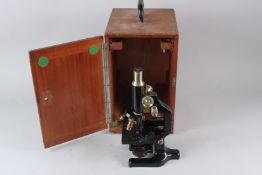 A MICROSCOPE, in a mahogany case.