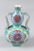 A CHINESE PORCELAIN GOURD SHAPED TWIN-HANDLED VASE, turquoise ground, painted with bats and other