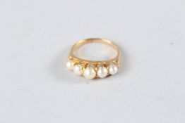 AN 18CT YELLOW GOLD FIVE STONE NATURAL PEARL RING.