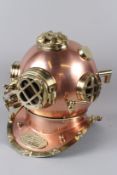 A GOOD REPRODUCTION COPPER AND BRASS DIVER'S HELMET. 33cms wide.