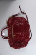 PRADA, A LADIES RED LEATHER HANDBAG with dust bag and certificate.