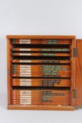 A QUANTITY OF MICROSCOPE SLIDES, contained in a mahogany cabinet.