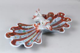 A HEREND PORCELAIN SWEETMEAT DISH, with two shell shaped dishes united by a dolphin. 46cms wide.