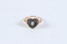 A GOLD AND DIAMOND HEART SHAPED RING.