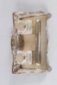 A SILVER DESK STAND, with pierced sides, pair of silver and glass inkwells on paw feet, marks