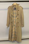 A BURBERRY TRENCH COAT.