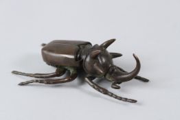 A JAPANESE BRONZE RHINOCEROS BEETLE with articulated wing. 11cms.