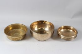 THREE 19TH CENTURY INDIAN BRASS CIRCULAR BOWLS. 17cms, 20cms and 21cms diameter.
