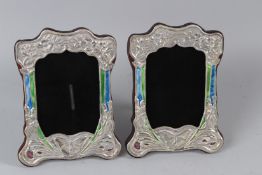 A PAIR OF SILVER AND ENAMEL PHOTO FRAMES.