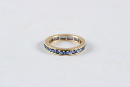 AN 18CT GOLD SAPPHIRE ETERNITY RING.