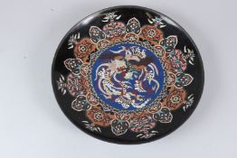 AN EARLY 20TH CENTURY JAPANESE CLOISONNE CHARGER, the centre decorated with a phoenix. 36cms