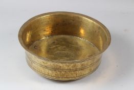 A 19TH CENTURY INDIAN CIRCULAR BRASS BOWL. 30cms diameter.