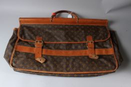 A LOUIS VUITTON HOLDALL, with double straps and buckles. 65cms wide.