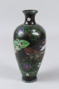 A 20TH CENTURY JAPANESE CLOISONNE VASE, decorated with panels of butterfly designs. 21cms high.