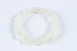 A WHITE JADE TWIST BANGLE. 9cms.