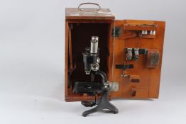 A CARL ZEISS BINOCULAR MICROSCOPE, No. 76920, with accessories, in a fitted case.