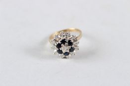 A 9CT GOLD, SAPPHIRE AND DIAMOND CLUSTER RING.