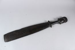 A 19TH CENTURY MAORI OR SOUTH SEA ISLANDS HARDWOOD PADDLE FORM CLUB, the broad blade carved with
