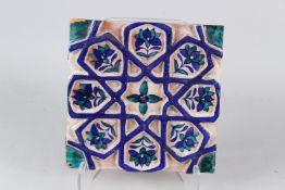 A FINE 19TH CENTURY NORTH INDIAN MULTAN GLAZED POTTERY TILE with geometric designs. 28cms long.