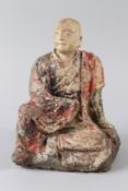 AN 18TH CENTURY CARVED WOOD AND COMPOSITE POLYCHROME DECORATED SEATED BUDDHA. 28cms high.