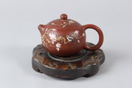 A FINE CHINESE YIXING TEAPOT with hardwood stand. Base 13.5cms. Teapot 8.5cms.