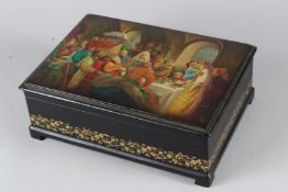 A LARGE RUSSIAN LACQUER RECTANGULAR BOX, the hinged cover painted with figures at a wedding. 33cms
