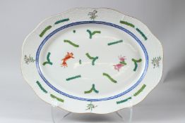 A HEREND PORCELAIN OVAL DISH, with basketweave border, painted with fish and seaweed. 42cms wide.
