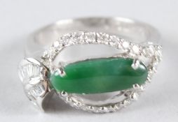 AN 18CT GOLD, JADE AND DIAMOND RING.