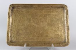 A 19TH CENTURY PERSIAN QAJAR BRASS TRAY engraved with figural decoration. 51cms x 36cms.