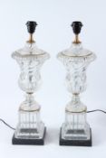 A PAIR OF GLASS URN SHAPED TABLE LAMPS, on square marble bases. 58cms high.