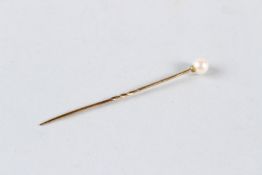 A VICTORIAN 9CT GOLD STICK PIN.