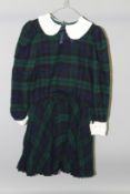 A GREEN AND BLUE TARTAN DRESS, with white collar and cuffs.