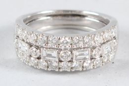 AN 18CT WHITE GOLD DIAMOND BAND RING, set with brilliant and baguette cut diamonds.