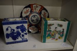 Two Chinese flower bricks and an Imari dish.