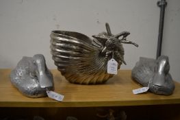 A pair of aluminium models of ducks and an aluminium planter modelled as a shell.