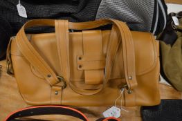 A tan leather handbag.