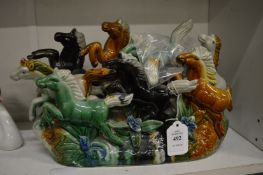 A sancai glazed Chinese figure group of horses.