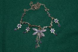 A dragonfly pendant and chain.