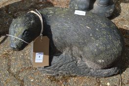 A reconstituted stone garden ornament modelled as a otter.