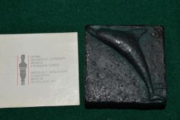 A small dolphin paperweight.