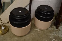 A pair of turned wood circular stands with associated bases.