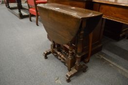 An oak drop-leaf gate-leg occasional table.