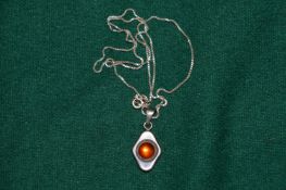 A silver pendant and chain.